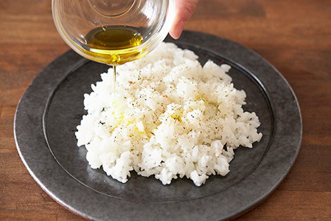 写真：ごはんを皿に盛り、ハーブ塩とガーリックオイルをかける